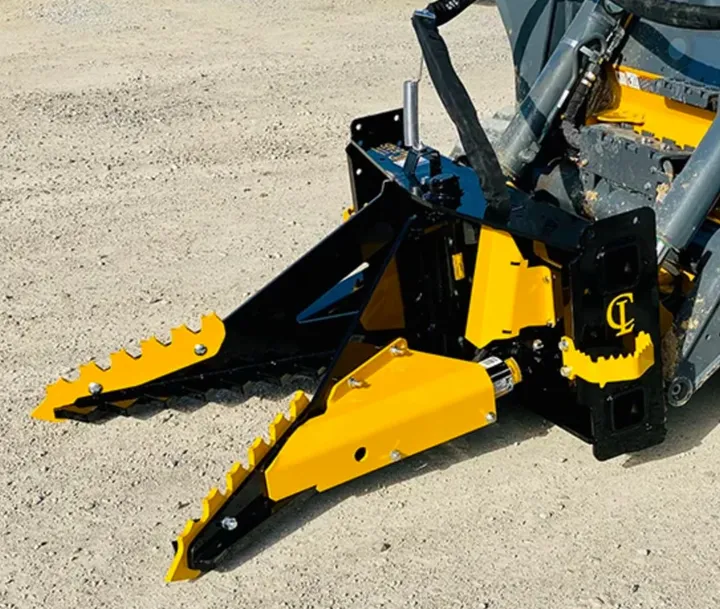 Challenger Tree Puller on a skid steer, yellow jaws with serrated teeth
