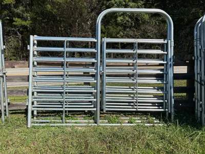 Galvanized 10-foot combo bow gate, half gate and half panel, against a wood fence