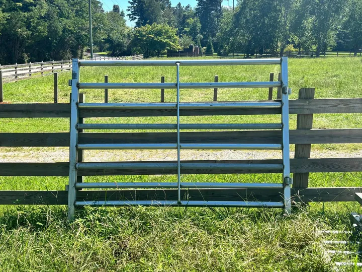 Galvanized 8-foot sweep panel in front of a wood fence