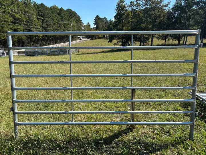 Galvanized 6x10 heavy corral panel standing in a pasture