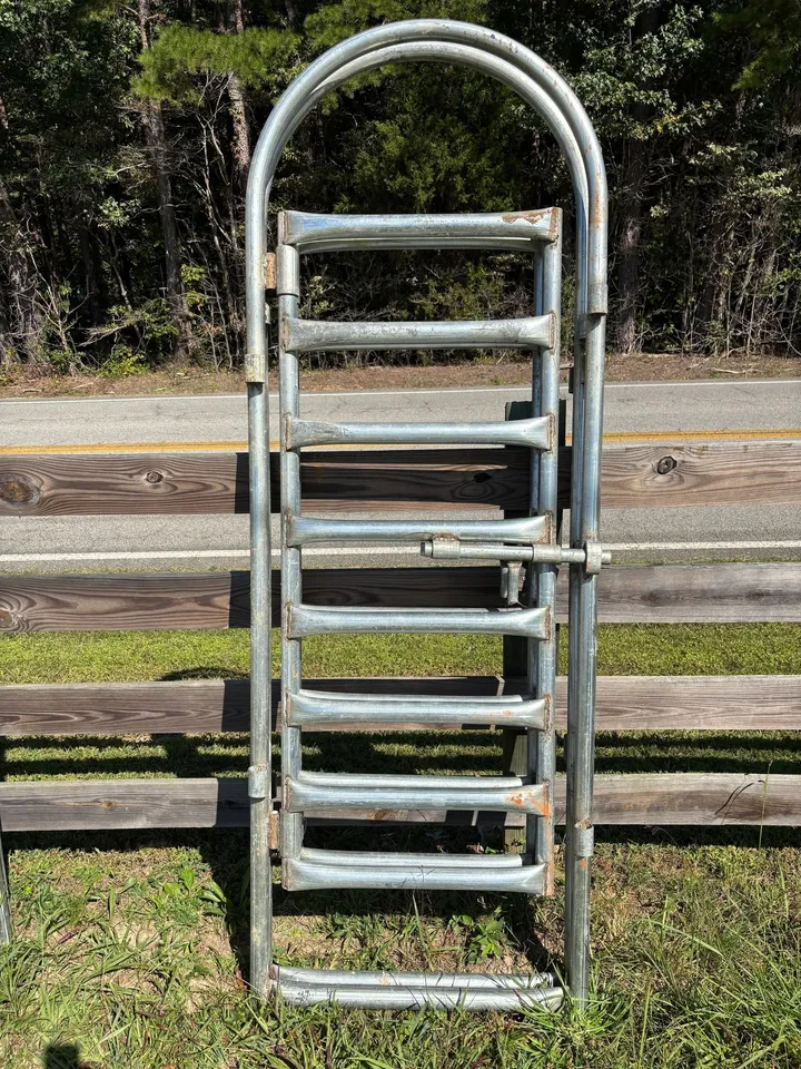 Narrow 28-inch galvanized heavy bow gate standing upright