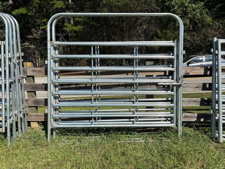 Galvanized 8-foot heavy bow gate against a wood fence
