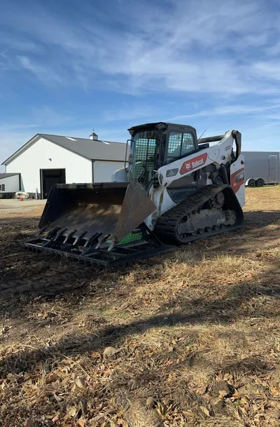 94-inch B-Built Rake-N-Ator on a compact track loader in a field