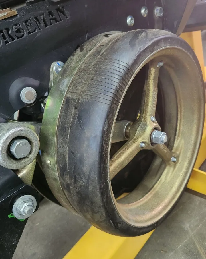 Norseman scraper ring installed on a planter row unit gauge wheel