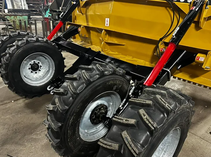 Close-up of V-Shape Box Scraper pivot tires and hydraulic cylinders