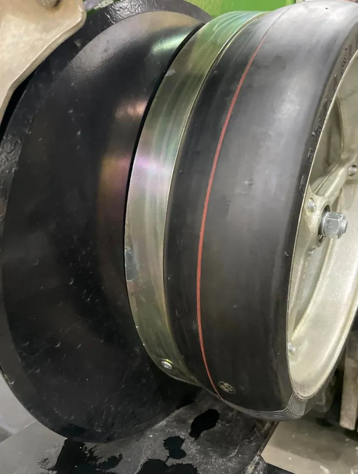 Close-up of a Norseman scraper ring keeping mud off a gauge wheel