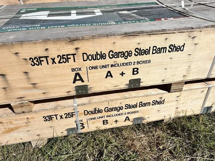 Two shipping crates labelled "33FT x 25FT Double Garage Steel Barn Shed", boxes A and B