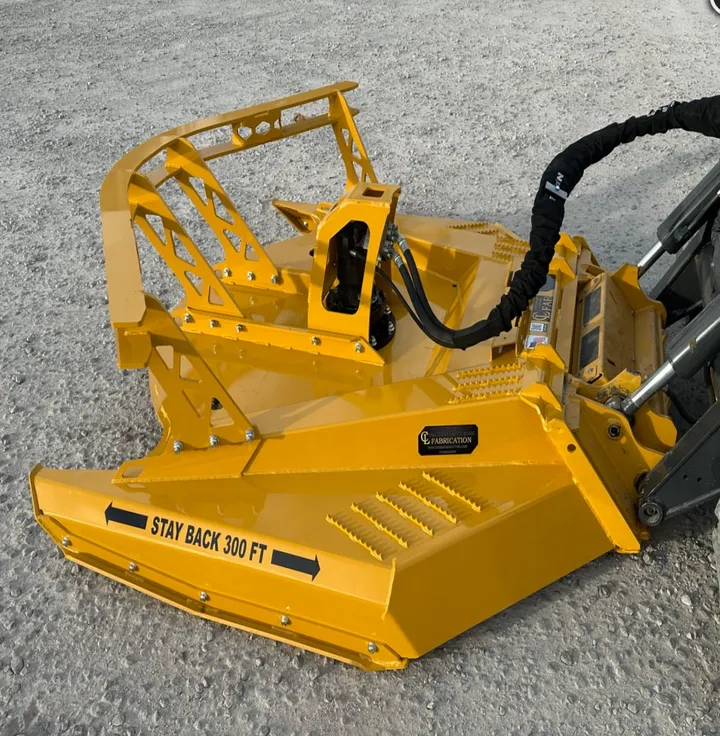 Yellow brush cutter on a skid steer, side view