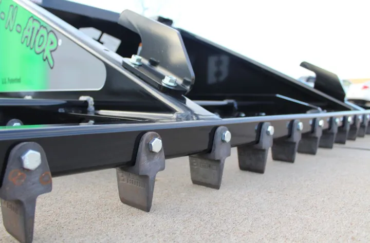 Close-up of the Rake-N-Ator grading bars and replaceable teeth