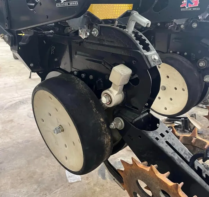 Kinze planter row unit fitted with Norseman gauge wheel arms, side view