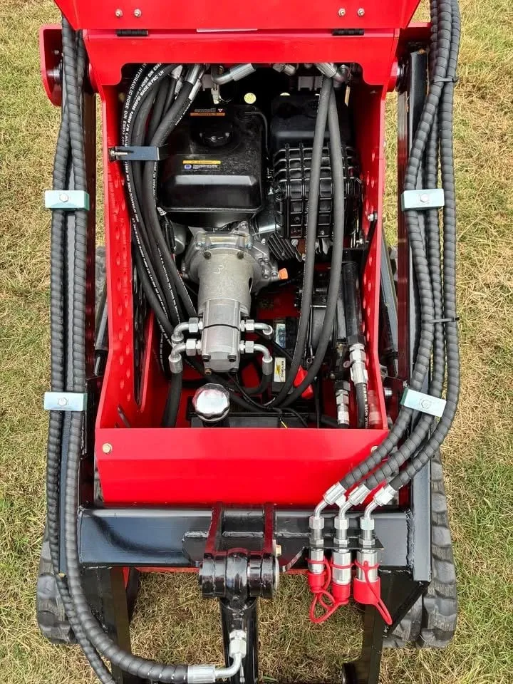 SSL60 mini skid steer engine and hydraulic pumps with the hood open