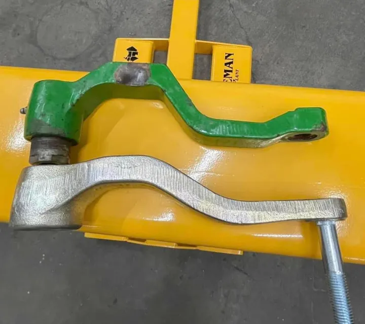 Norseman gauge wheel arm next to a stock arm on a planter