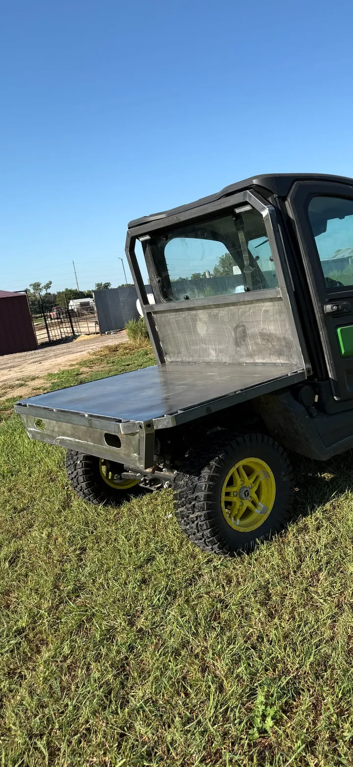 Green side by side with a black flat bed, side view