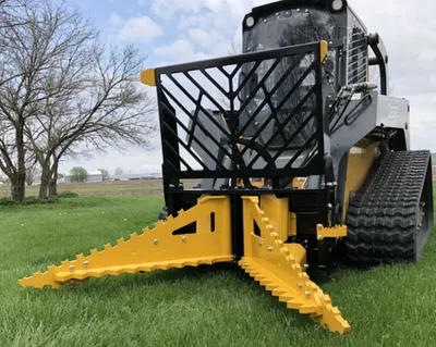 Dominator Tree Puller on a compact track loader in a field