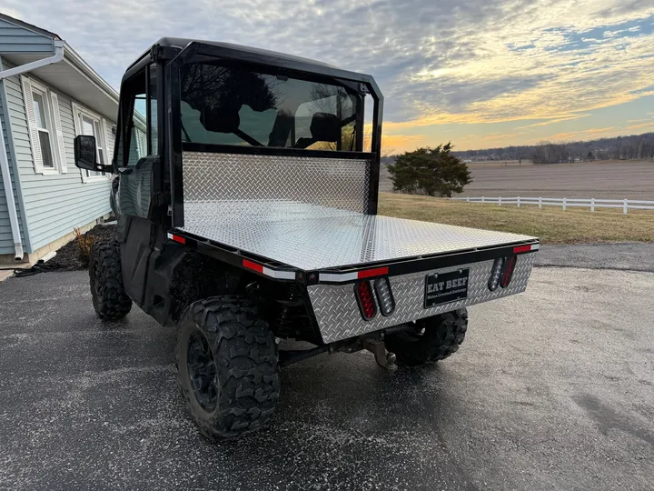 Side by side with flat bed, rear three-quarter view outdoors